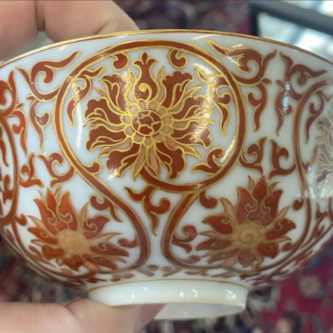 Piece A: iron-red bowl with gilt lotus scrolls, close-up