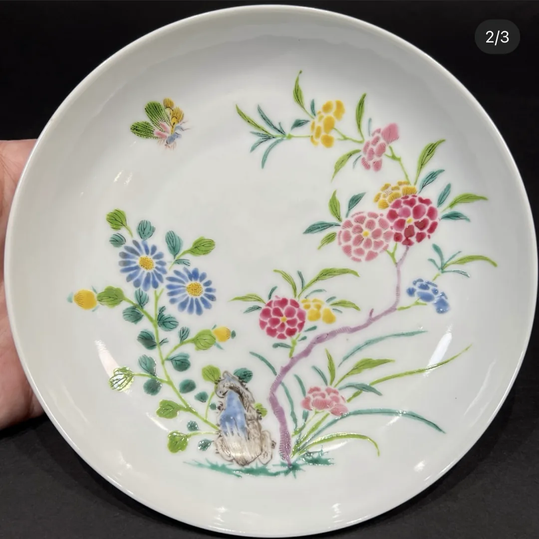 Piece A: famille rose plate painted with flowering plants beside a rock